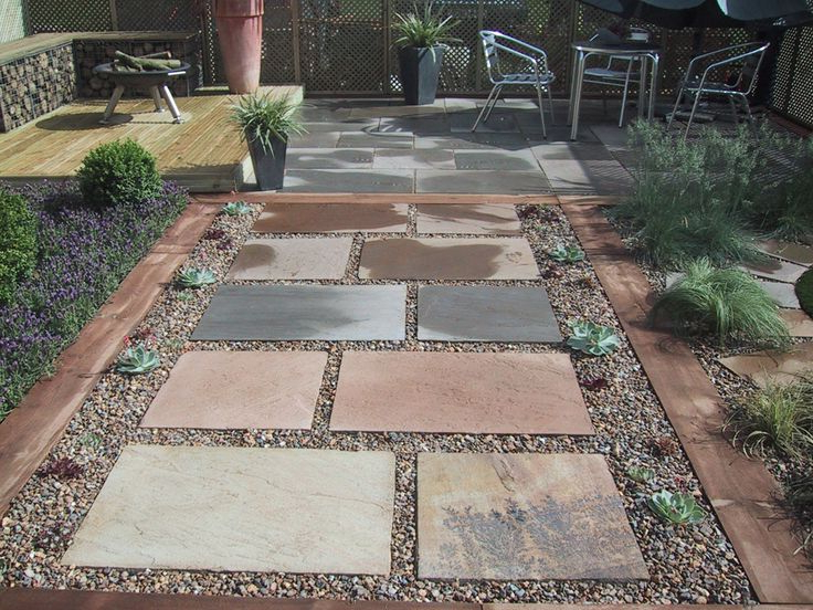 Stepping Stones In Gravel Patio Area And Raised Deck With