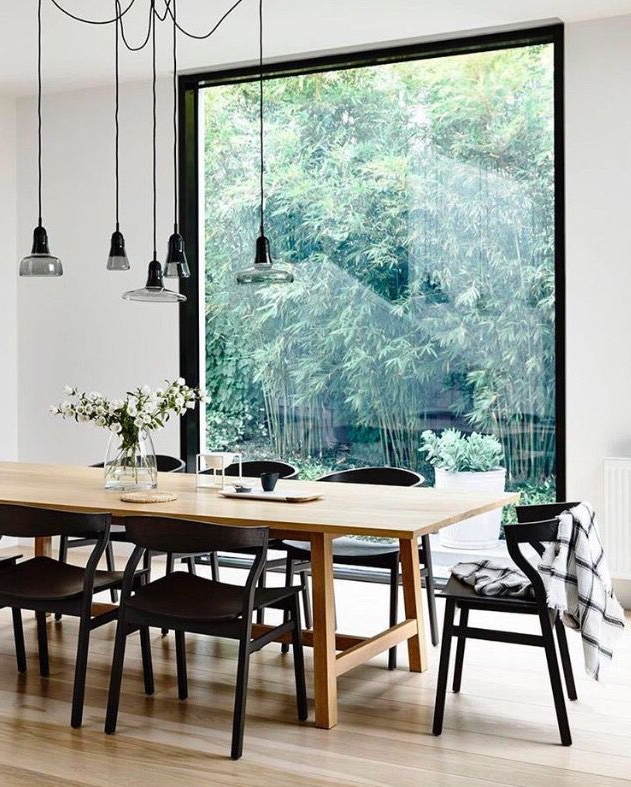 Wood Table With Black Chairs Wood Floor And White Walls